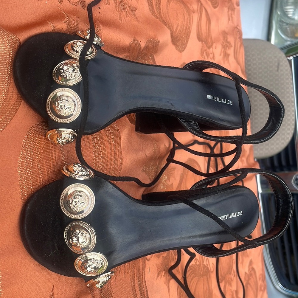 Black straps pretty little thing heels with gold embellishments